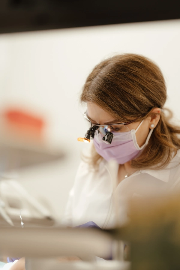 Dr. Alavi wearing magnification loupes during dental treatment in Vancouver