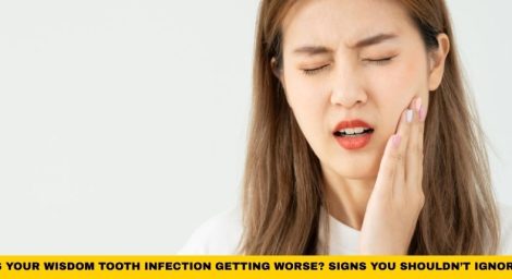 Person holding swollen jaw in pain showing symptoms of wisdom tooth infection and worsening wisdom tooth infection signs